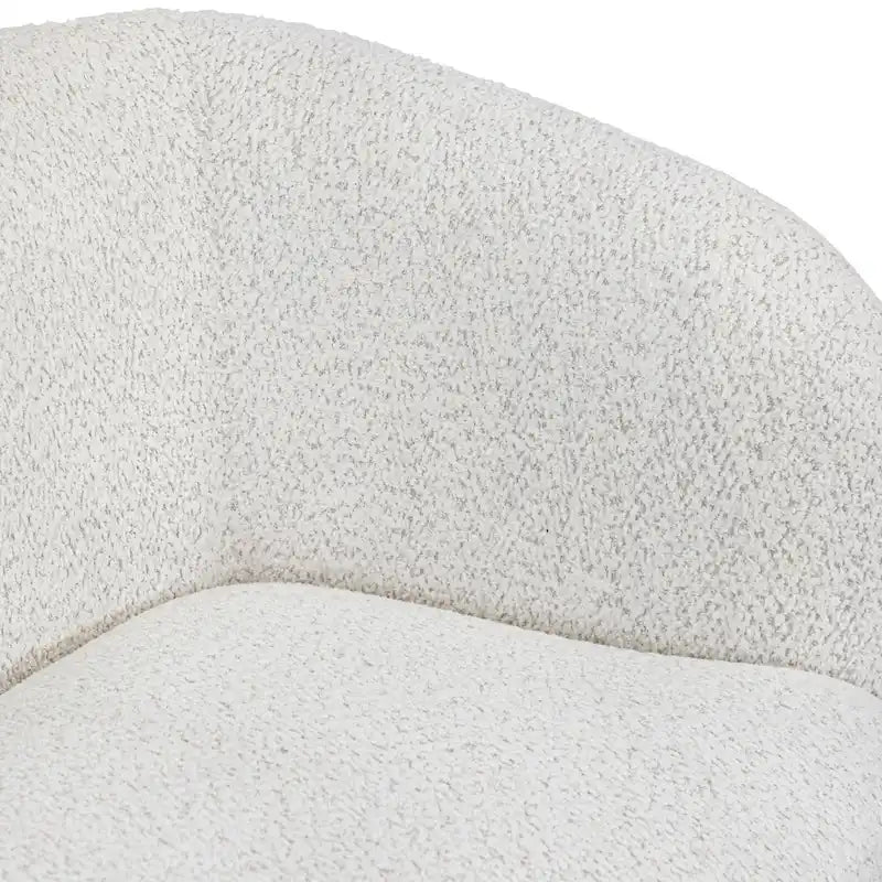 Fauteuil de style moderne doté d'accoudoirs incurvés, d'un coussin d'assise en forme de haricot et de pieds ronds en bois, recouvert d'un tissu bouclé.
